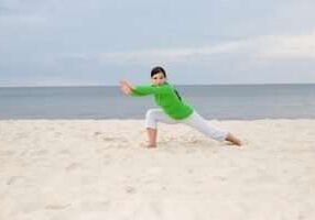 attractive woman doing exercise on the beach