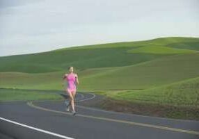 Runner on rural road in farm land